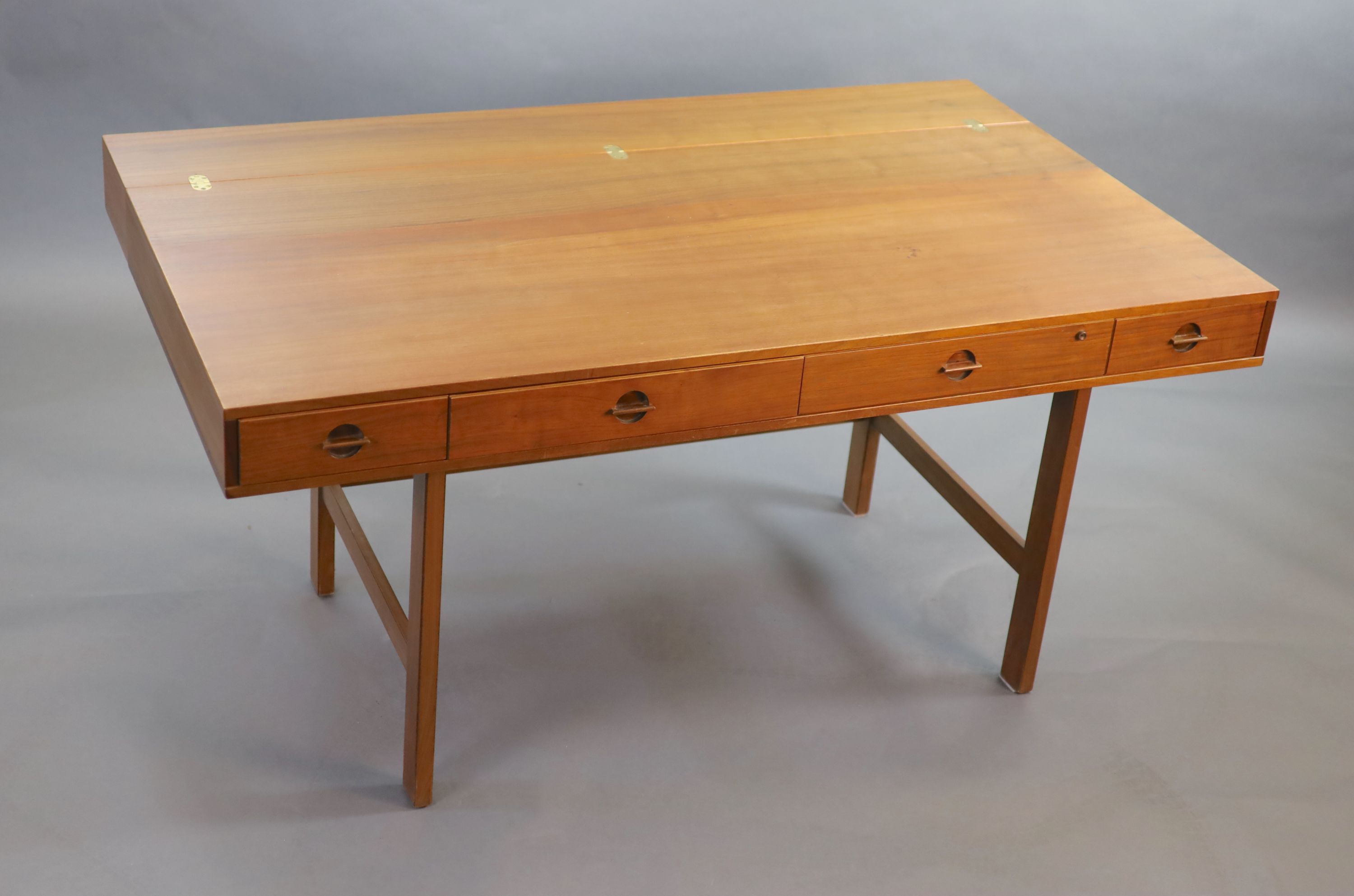 Jens Quistgaaard for Lovig, a Danish teak flip top desk circa 1973, W. 162. H. 86. D. 73 cm.
